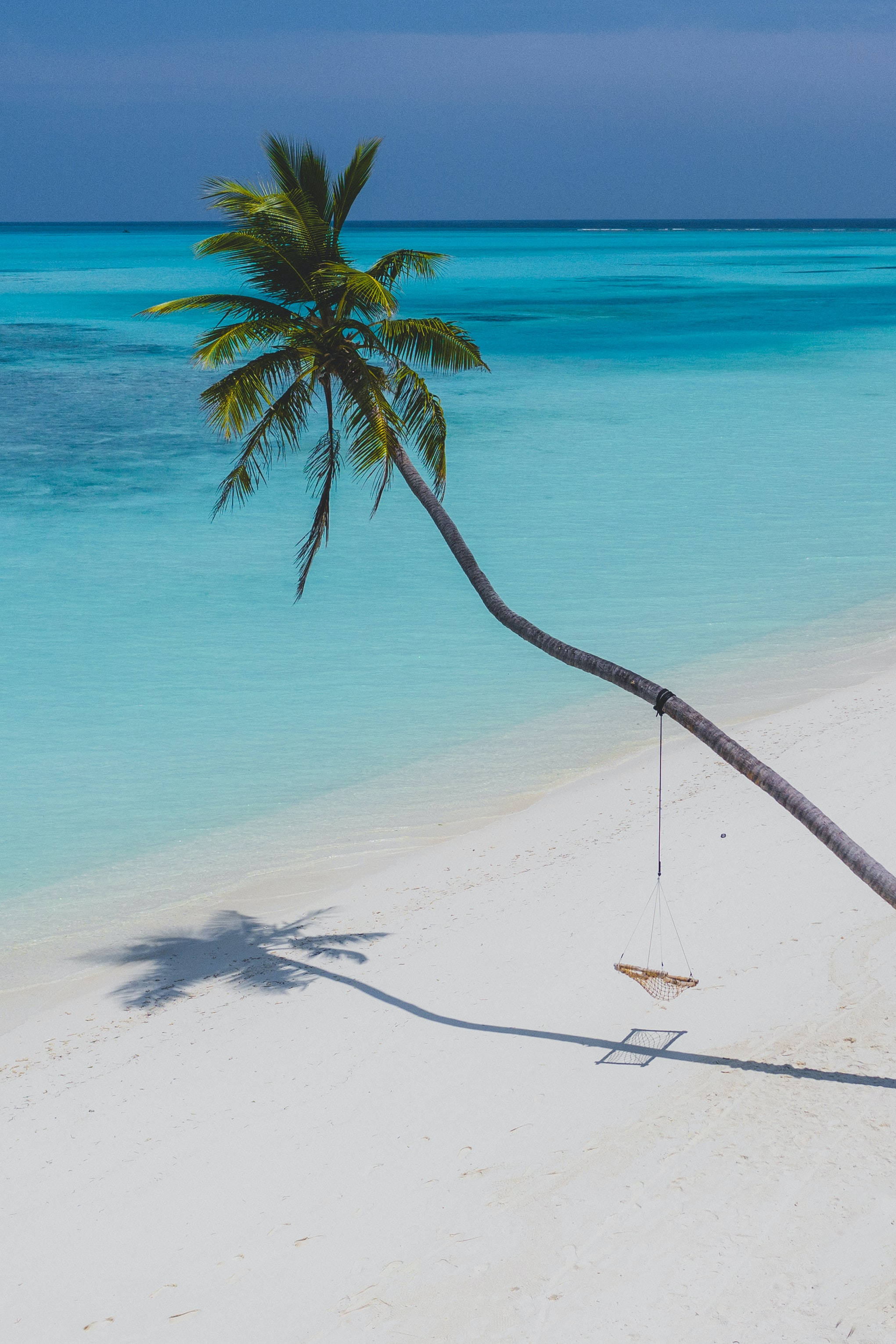 Relaxing on a tropical beach, feeling the summer sun وال پیپر